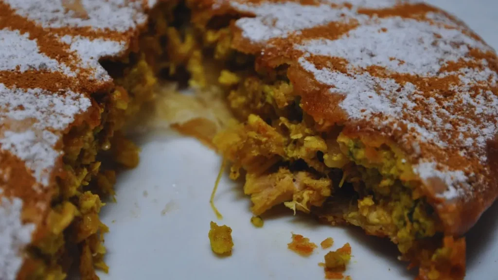 Traditional Moroccan Chicken Pastilla topped with powdered sugar and filled with spiced chicken and almonds